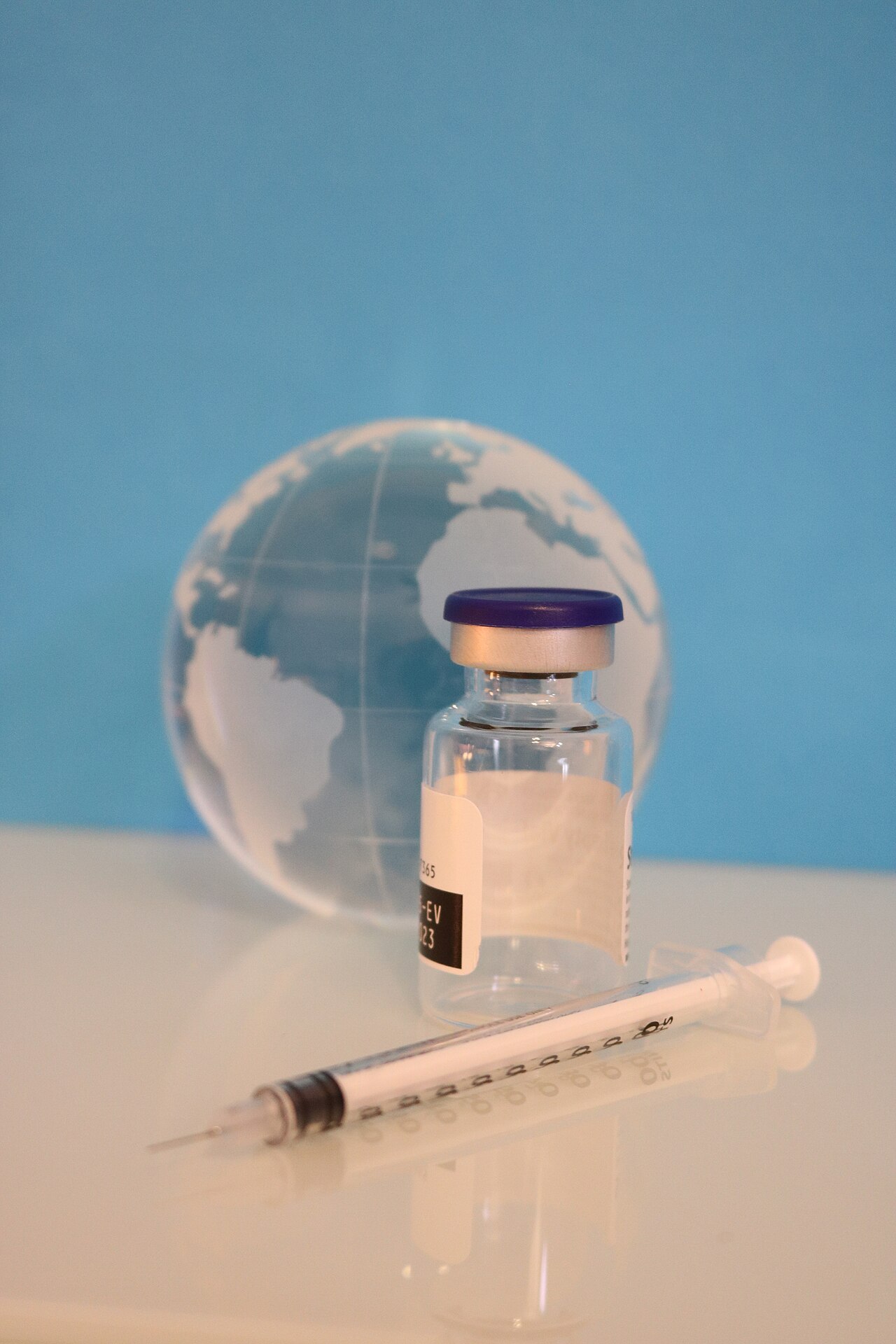 A syringe, vaccine bottle, and glass globe. Credit: NIAID