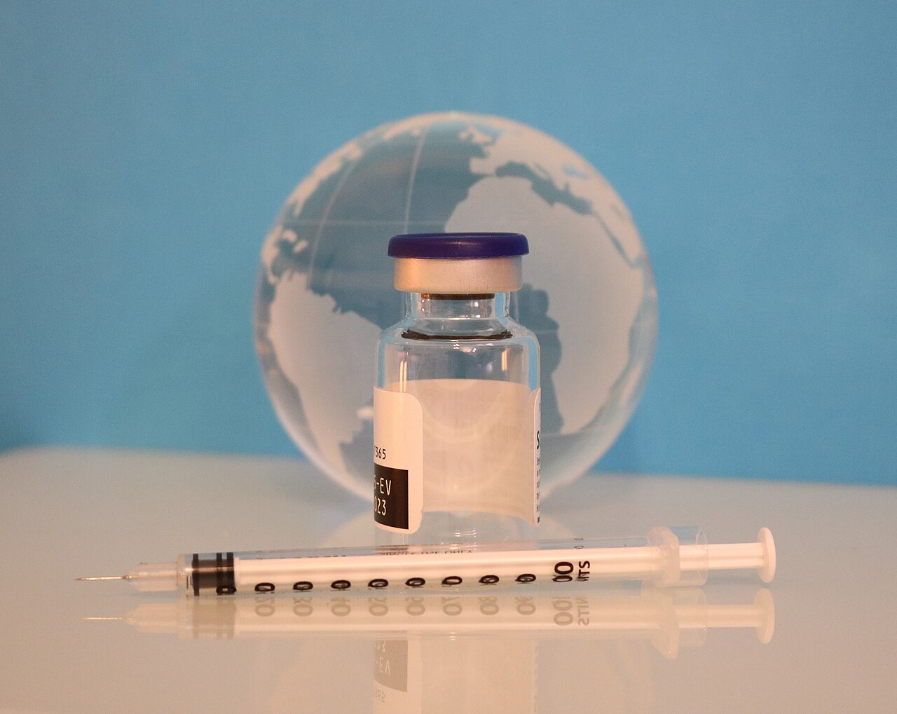 A syringe, vaccine bottle, and glass globe. Credit: NIAID