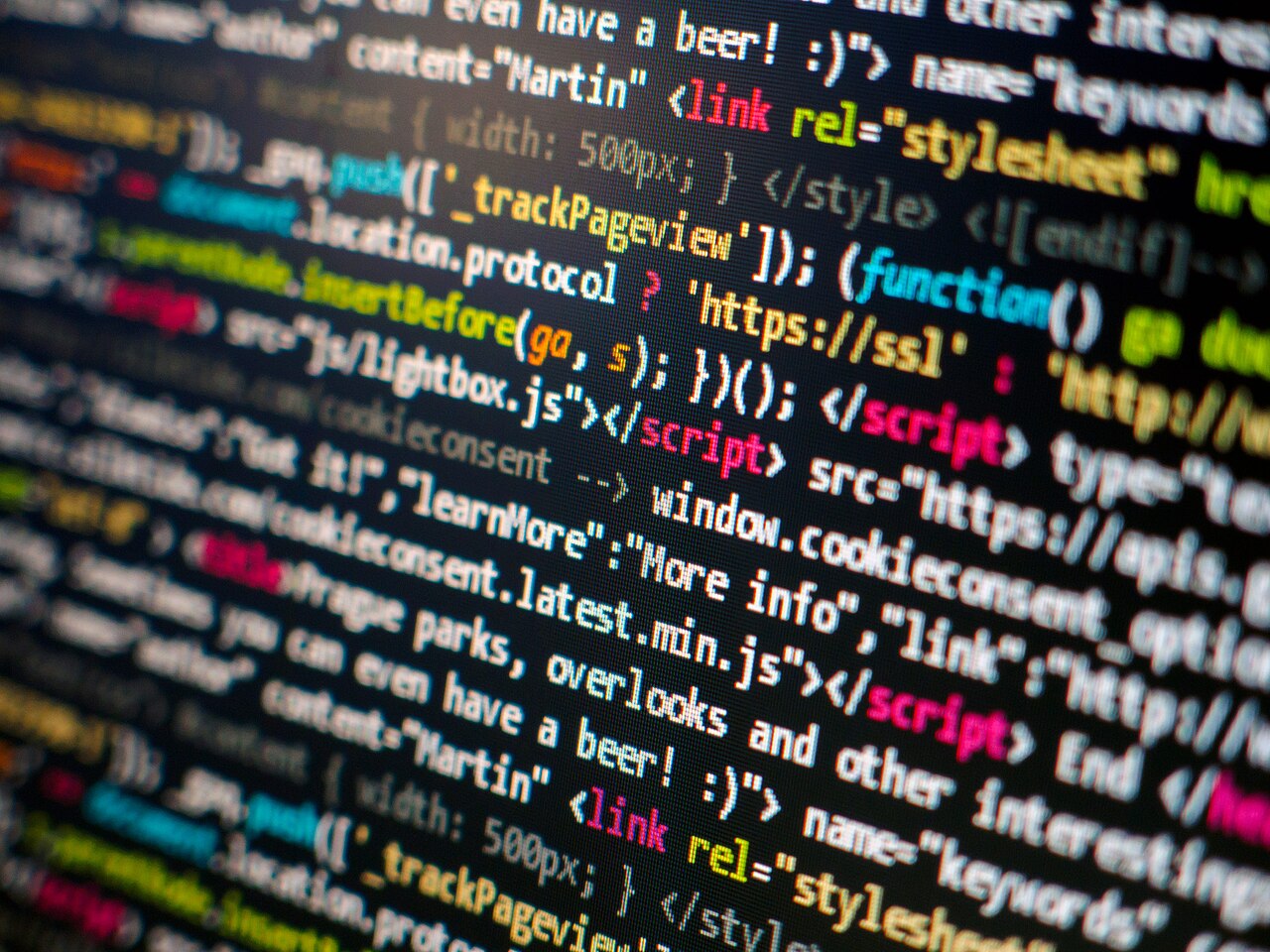 HTML and Javascript code with highlighted scripts and functions. Script on a computer with source code – screen of a software developer. Photographed